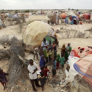 Internally displaced Somalis stand outside a makeshift Muslim Madrasa (Islamic school) at the Halabokhad IDP settlement in Galkayo, northwest of Somalia's capital Mogadishu, July 20, 2011.