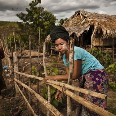 Two villagers in New Ahtet Kawin in front of their homes. 