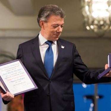 Nobel Peace Prize laureate Colombian President Juan Manuel Santos poses with the medal and diploma during the Peace Prize awarding ceremony at the City Hall in Oslo, Norway on December 10, 2016.