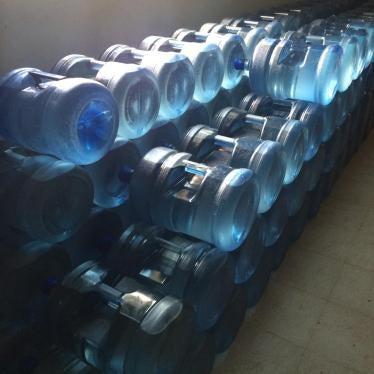 Bottled water stored in Shoal Lake 40 First Nation community building. The First Nation has been on a boil water advisory for close to two decades. Ontario, Canada, August 2015.