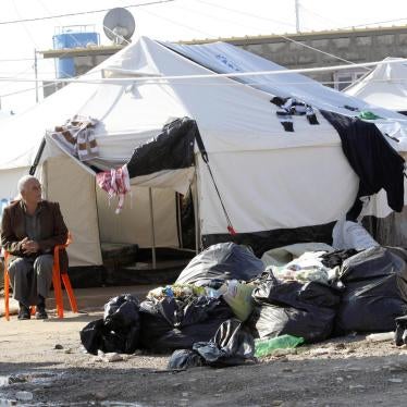 A man sits on a chair at a camp for internally displaced persons on the outskirts of Kirkuk, December 17, 2014. © 2014 Reuters