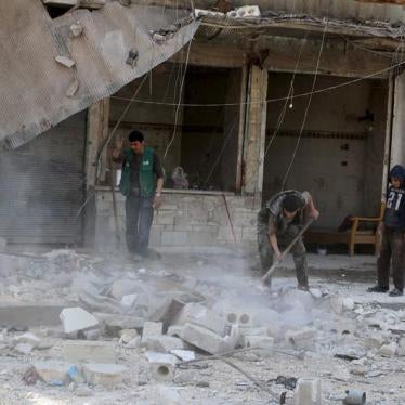 Residents remove debris after an airstrike on the neighborhood in Aleppo, Syria, April 11, 2016.