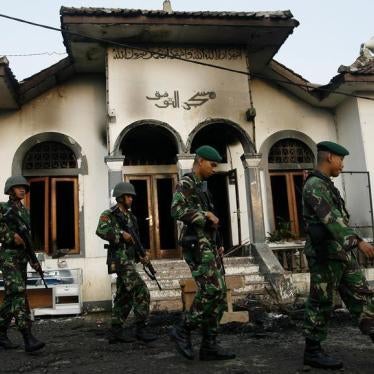Soldiers walk past a burnt mosque owned by followers of the minority Islamic sect, Ahmadiyah, in Ciampea, a village in Indonesia's West Java province October 2, 2010.