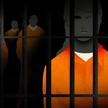 prisoners stand behind bars 