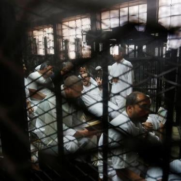 Detainees sit behind bars during the trial of 738 Muslim Brotherhood members accused of staging an armed sit-in at Rabaa square, at a court on the outskirts of Cairo, Egypt, May 31, 2016.