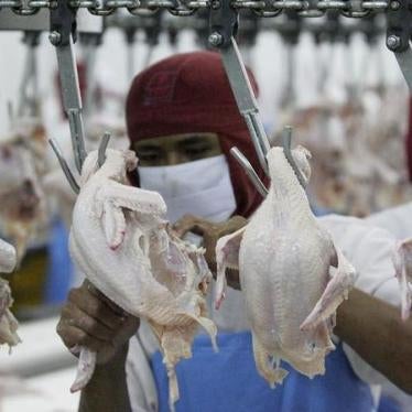 A worker cuts poultry at a factory in Chonburi province. 