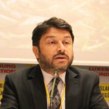 Taner Kilic, head of Amnesty International Turkey, speaks at a conference.