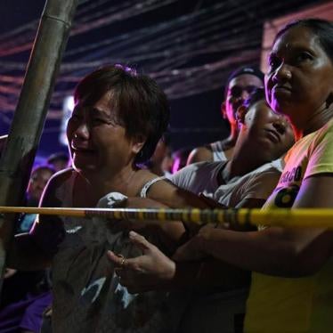 A victim’s relative cries behind the police line at the site of a drug-related shooting in metro Manila, Philippines, June 19, 2017.