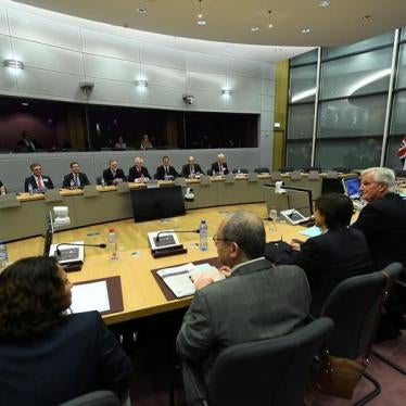 Britain's Secretary of State for Exiting the European Union David Davis and his delegation sit across from European Union's chief Brexit negotiator Michael Barnier and his delegation at the start of their first day of talks at the European Commission in B