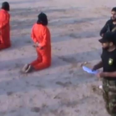 The above image is a screenshot from a video posted on July 24, 2017 showing the apparent summary execution by LNA fighters of 20 prisoners, whom the commander, believed to be ICC suspect Mahmoud Al-Werfalli (wearing cap),  accuses of “terrorism.”