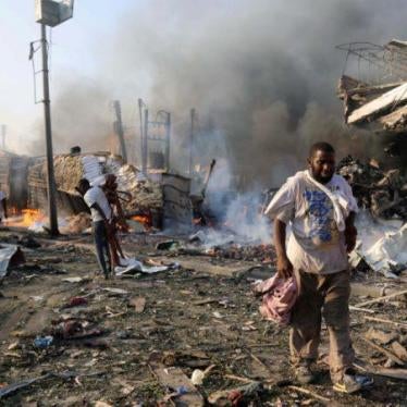 Civilians walk at the scene of an explosion in KM4 street in the Hodan district of Mogadishu, Somalia October 14, 2017
