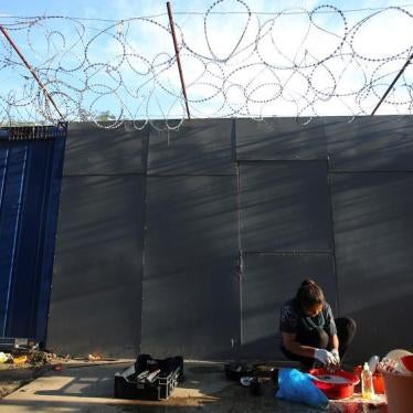 A refugee washes clothes on the Hungary-Serbia border, on the Serbian side of a transit zone set up by Hungarian authorities to filter refugees at Roszke, Hungary, September 2, 2016. 