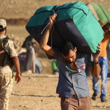 Syrian refugees carry belongings as they return to Syria after crossing the Jordanian border near the town of Nasib, in the southern province of Daraa, on August 29, 2017.  © 2017 Mohamad Abazeed, AFP, Getty Images