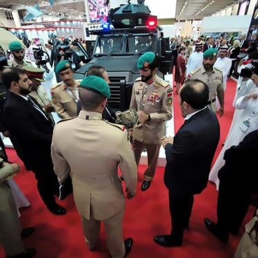 Head of Protocol and representative of the King of Bahrain, Brigadier Sheikh Nasser bin Hamad al Khalifa (C) inspects an armoured military ballistic helmet during inauguration of Bahrain International Defense Exhibition and Conference at the Bahrain Exhib