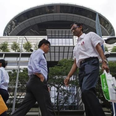 People walk past the Supreme Court in Singapore January 22, 2014.