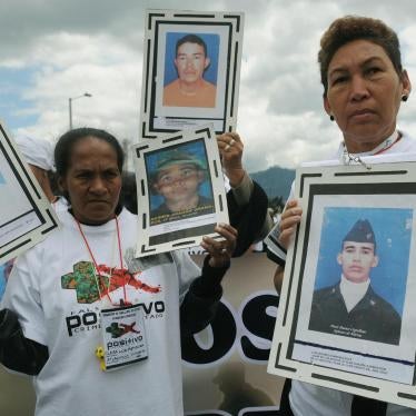 Relatives hold pictures of their beloved during a March 6, 2009 march in Bogota against the “false positive” killings and enforced disappearances.
