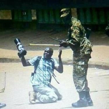Ugandan soldiers surround and beat photographer James Akena in Kampala during protests on August 20, 2018.