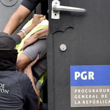 Attorney's General office's special agents embark into an armoured car some of the 27 municipal policemen involved in an attack against students in Iguala last month and now presented to the press in Mexico City on October 17, 2014. 