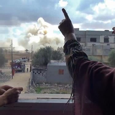 A woman yells as a neighbor’s house is destroyed. © 2014 Private