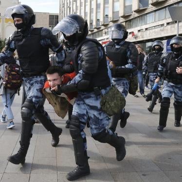 Police officers detain a protestor, during a peaceful protest in the center of Moscow, Russia, Saturday, Aug. 3, 2019.