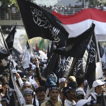 Muslim protesters display flags with Arabic writings that read: "There's no God but Allah and Muhammad is his messenger"