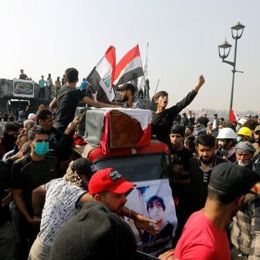 As part of a funeral procession, people transport the coffin of a protester killed at a Baghdad demonstration, November 24, 2019. 