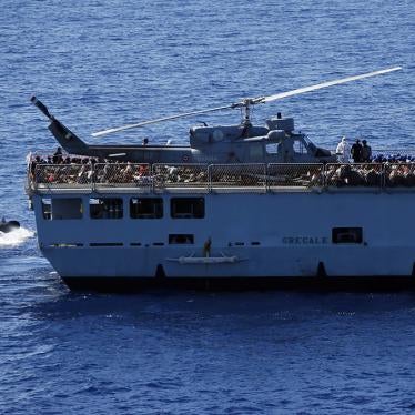 Migrants are transfered by Italian sailors from the German combat supply ship 'Frankfurt am Main' to the their ship 'Grecale' after being rescued during EUNAVFOR MED Operation Sophia in the Mediterranean Sea off the coast of Libya, March 29, 2016.