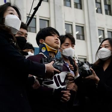 Cho Ju-bin, center, leader of South Korea's online sexual blackmail ring called "Nth room," is surrounded by journalists while walking out of a police station as he is transferred to prosecutors' office for further investigation in Seoul, South Korea