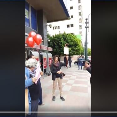 Screenshot of a live stream video from the protest showing Ahdaf Soueif, right, Laila Soueif, left, and Rabab al-Mahdy in between before they were arrested at the protest in downtown Cairo on March 18.