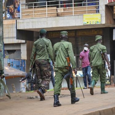 Ugandan police and other security forces chase people off the streets, after police cleared a stand of motorcycle taxis which are no longer permitted to operate after all public transport was banned for two weeks to halt the spread of the new coronavirus,