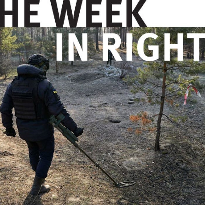 A figure walks through the woods.