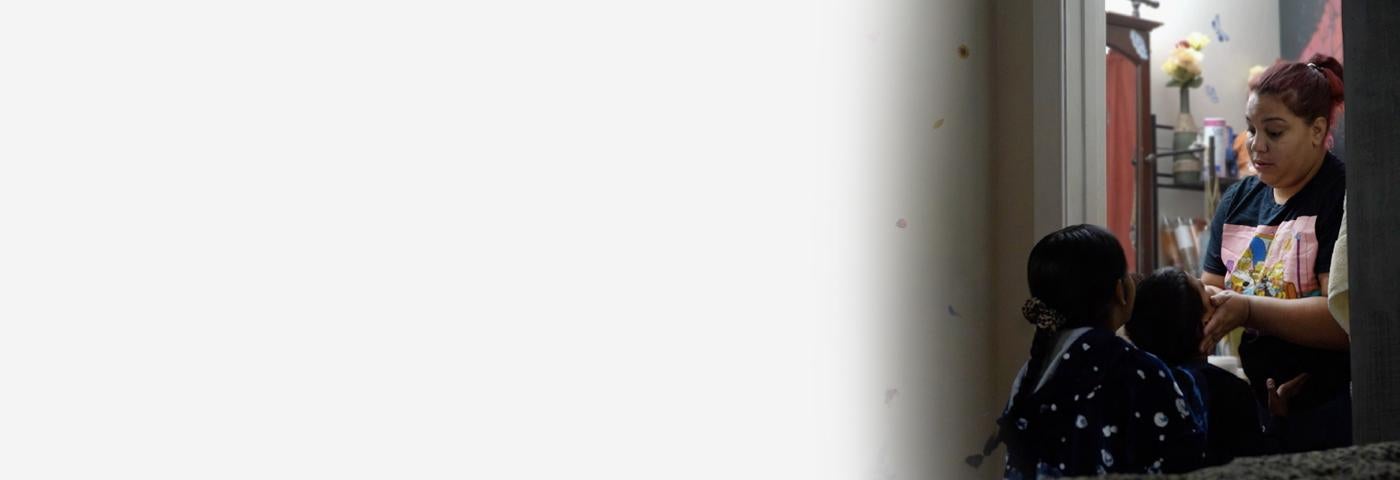 A woman holds her childs face